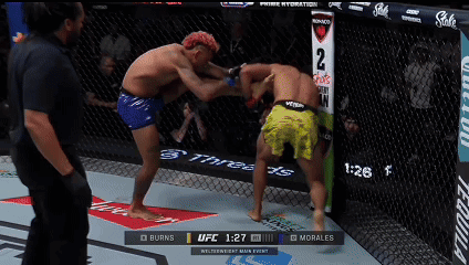 Two Men Fighting In Boxing Ring With UFC 1:27 Display GIF