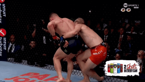 Two Men Fighting in Cage 2 Shots in Every Can