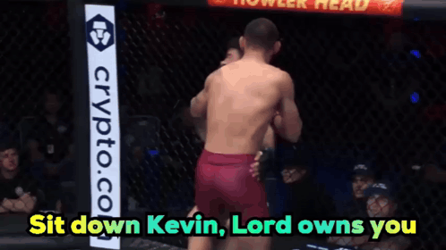 Two Men Fighting in Cage With Crypto.com Sign