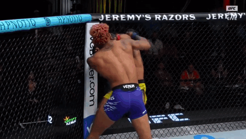 Two Men Fighting In Cage With Jeremy's Razors GIF