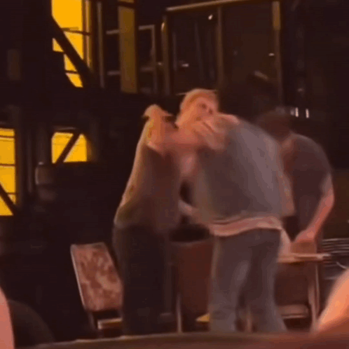 Two Men Fighting in Dark Room