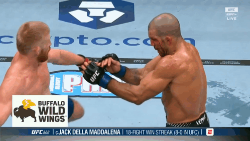 Two Men Fighting in Front of Buffalo Wild Wings Banner