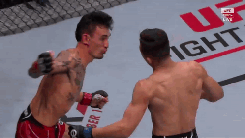 Two Men Fighting in Front of UFC Fight Sign