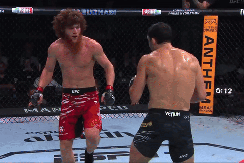 Two Men Fighting in Ring With Anthem Sign