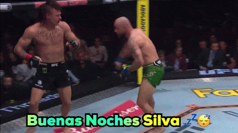 Two Men Fighting in Ring with Buenas Noches Silva