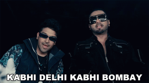 Two Men Giving A Thumbs Up With The Words Kabhi Delhi Kabhi Bombay In The Background GIF