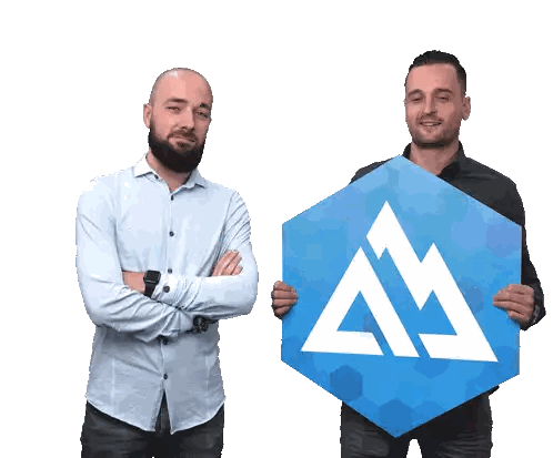 Two Men Holding Blue M Sign