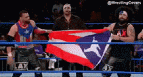 Two Men Holding Flag in Wrestling Ring