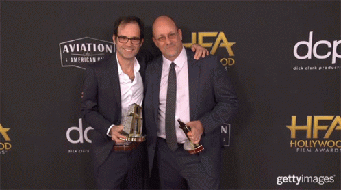 Two Men Holding Trophies Aviation And American Gin