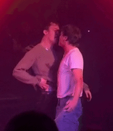 Two Men Hugging and Kissing on Stage