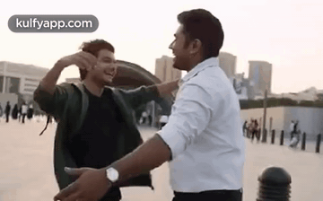 Two Men Hugging and Laughing