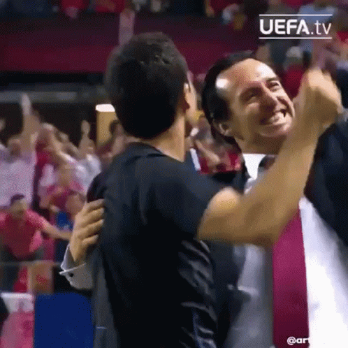 Two Men Hugging at Soccer Game