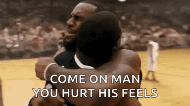 Two Men Hugging Each Other On A Basketball Court . GIF