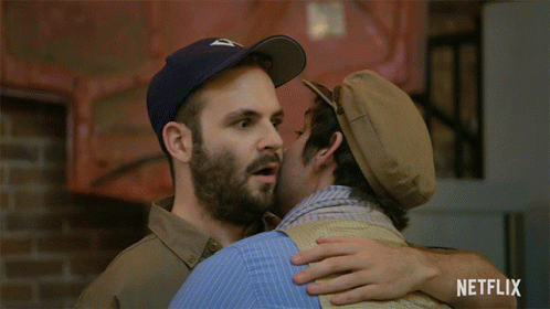 Two Men Hugging With Netflix Logo GIF