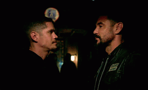 Two Men Hugging In Front Of Bud Light Sign GIF