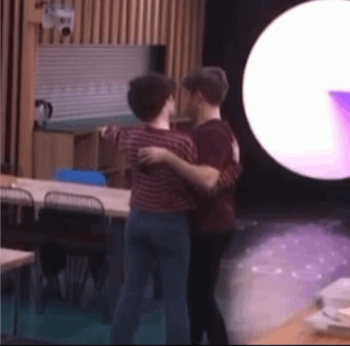 Two Men Hugging In Purple Light GIF