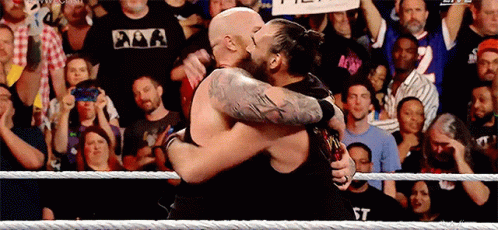 Two Men Hugging in Wrestling Ring