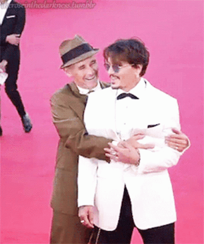 Two Men Hugging On Red Carpet GIF