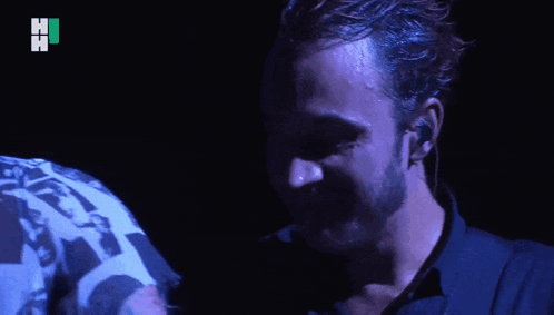 Two Men Hugging One Wearing Hi Shirt