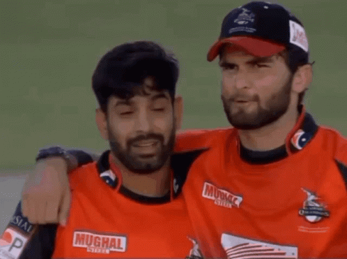 Two Men Hugging One Wearing Muchal Shirt GIF