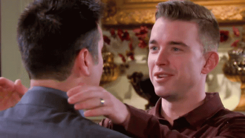 Two Men Hugging One With Ring