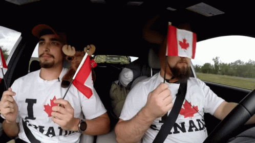 Two Men in a Car Holding Canadian Flags
