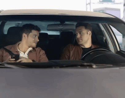 two men in a car talking to each other