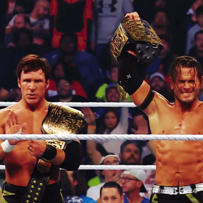 Two Men In A Wrestling Ring One Of Whom Is Wearing A Belt That Says ' Wwe ' On It GIF