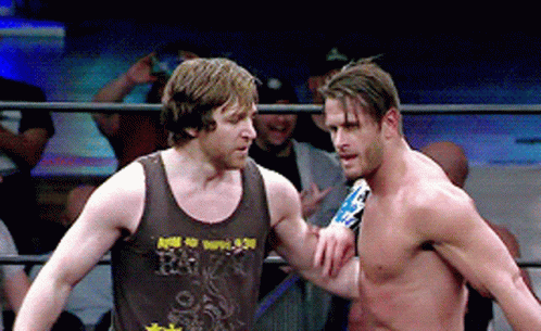 Two Men In A Wrestling Ring One Of Whom Is Wearing A Tank Top That Says R.i.p. GIF