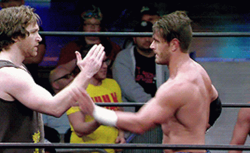 Two Men In A Wrestling Ring One Of Whom Is Wearing A Yellow Shirt That Says ' I Love You ' On It GIF