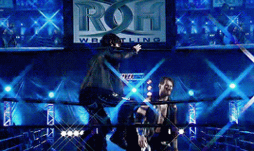 Two Men In A Wrestling Ring With A Sign That Says ' Roh Wrestling ' GIF