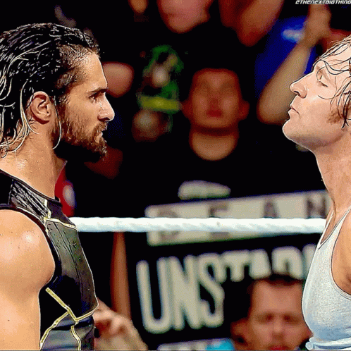 Two Men In A Wrestling Ring With A Sign That Says Unsuitable In The Background GIF