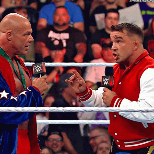 Two Men In A Wrestling Ring With One Wearing A Red Jacket That Says The Next Thing GIF