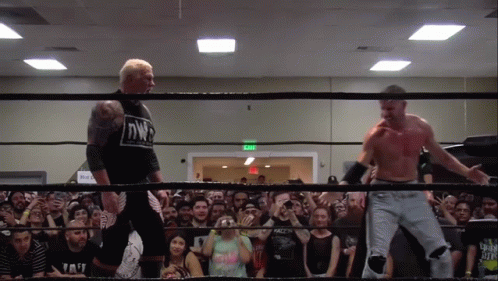 Two Men In A Wrestling Ring With One Wearing A Shirt That Says Nwp On It GIF
