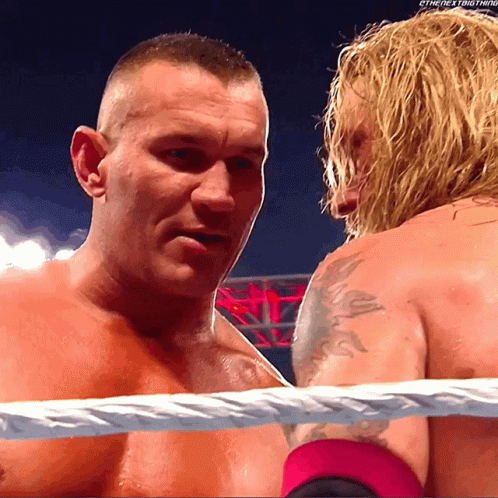 Two Men In A Wrestling Ring With The Words " The Next Thing " On The Bottom Right GIF