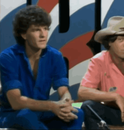 Two Men in Blue and Pink Shirts Sitting