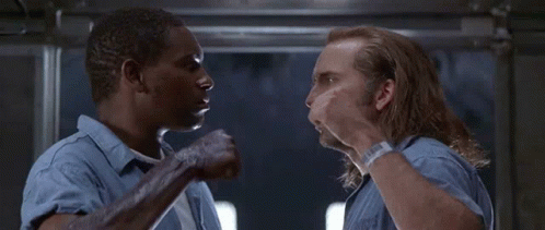Two Men in Blue Shirts Talking