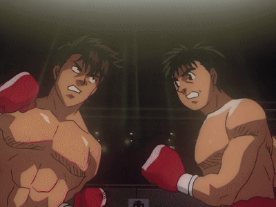 Two Men In Boxing Gloves Are Standing In A Ring GIF