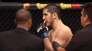 Two Men In Boxing Ring One Wearing UFC Gloves GIF