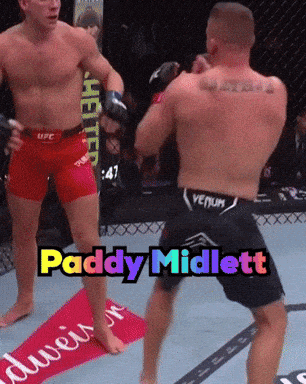 Two Men in Boxing Ring with Paddy Midlett