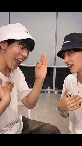 Two Men in Bucket Hats Laughing High Five