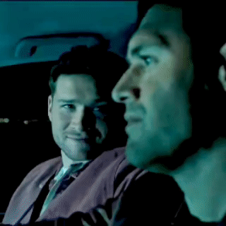 Two Men in Car Looking at Something