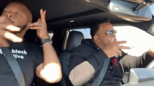 Two Men in Car One Wearing Black T-Shirt Saying Black Live