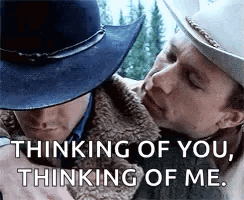 Two Men In Cowboy Hats Are Hugging Each Other And Talking . GIF