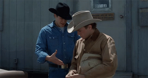Two Men In Cowboy Hats Are Standing In Front Of An Office Door GIF