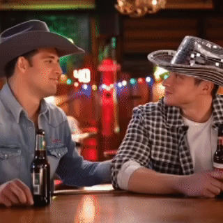 Two Men in Cowboy Hats Sitting at Bar