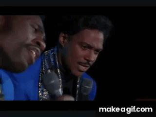 Two Men In Dark Room One Holding Microphone GIF