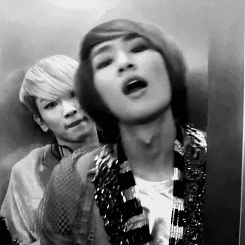 Two Men in Elevator One Making Funny Face