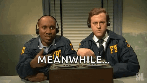 Two Men In Fbi Uniforms Are Sitting At A Table And One Of Them Says Meanwhile GIF