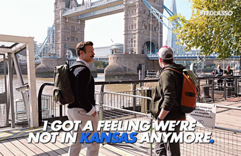Two Men in Front of Bridge Saying I Got a Feeling We're Not in Kansas Anymore